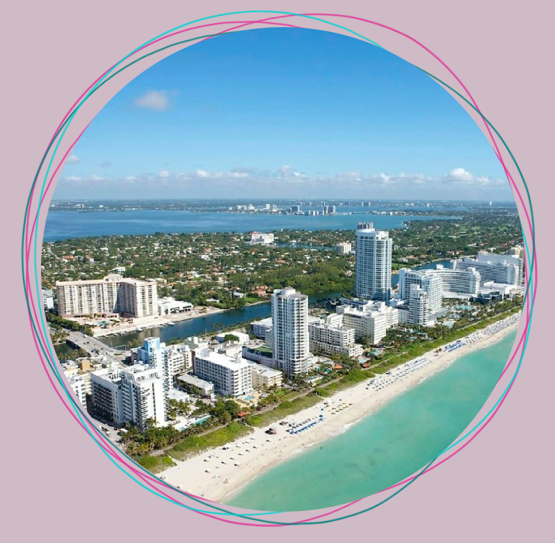 Aerial view of a coastal city with skyscrapers and white sandy beach, bordered by a circular pink frame.